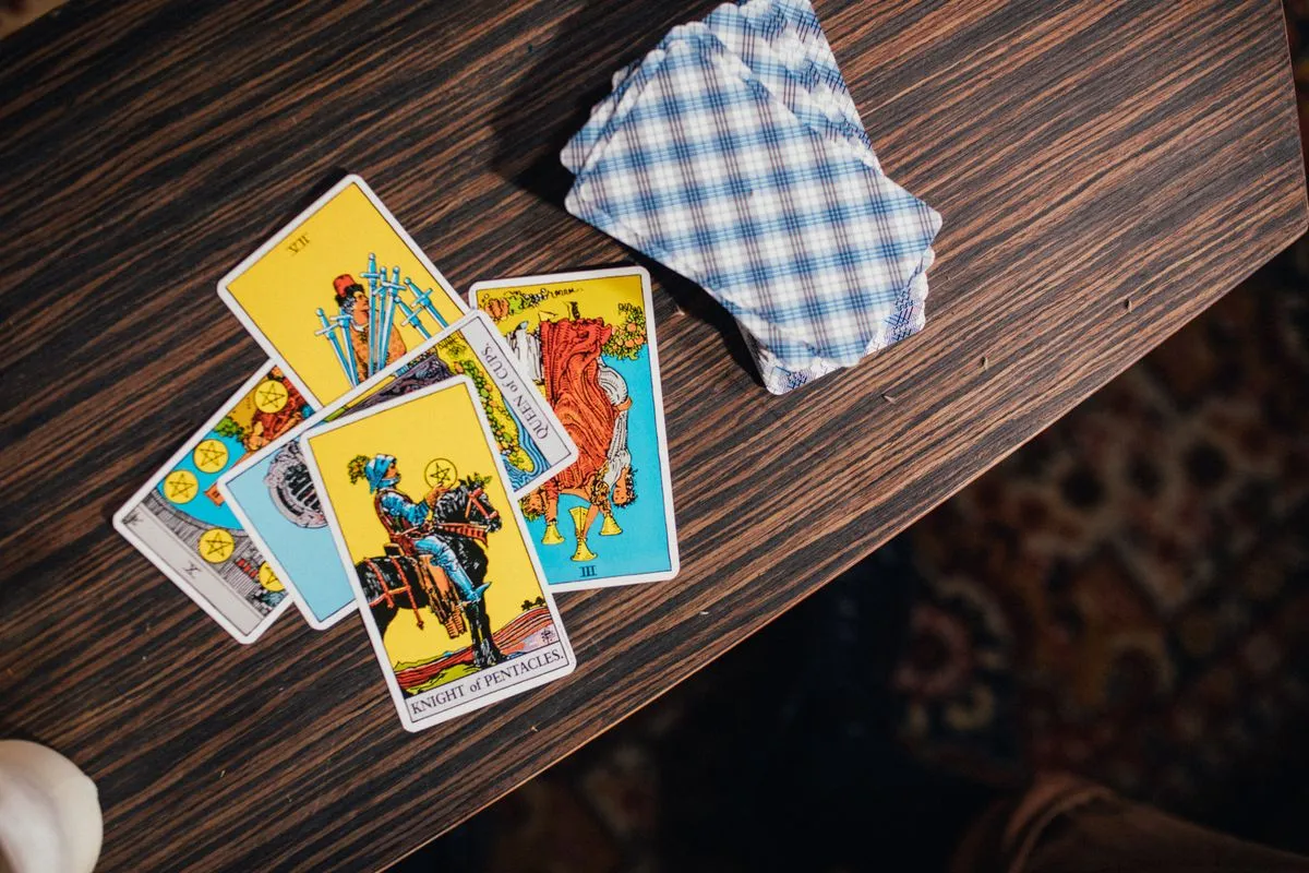 Tarot cards spread across a textured wooden table
